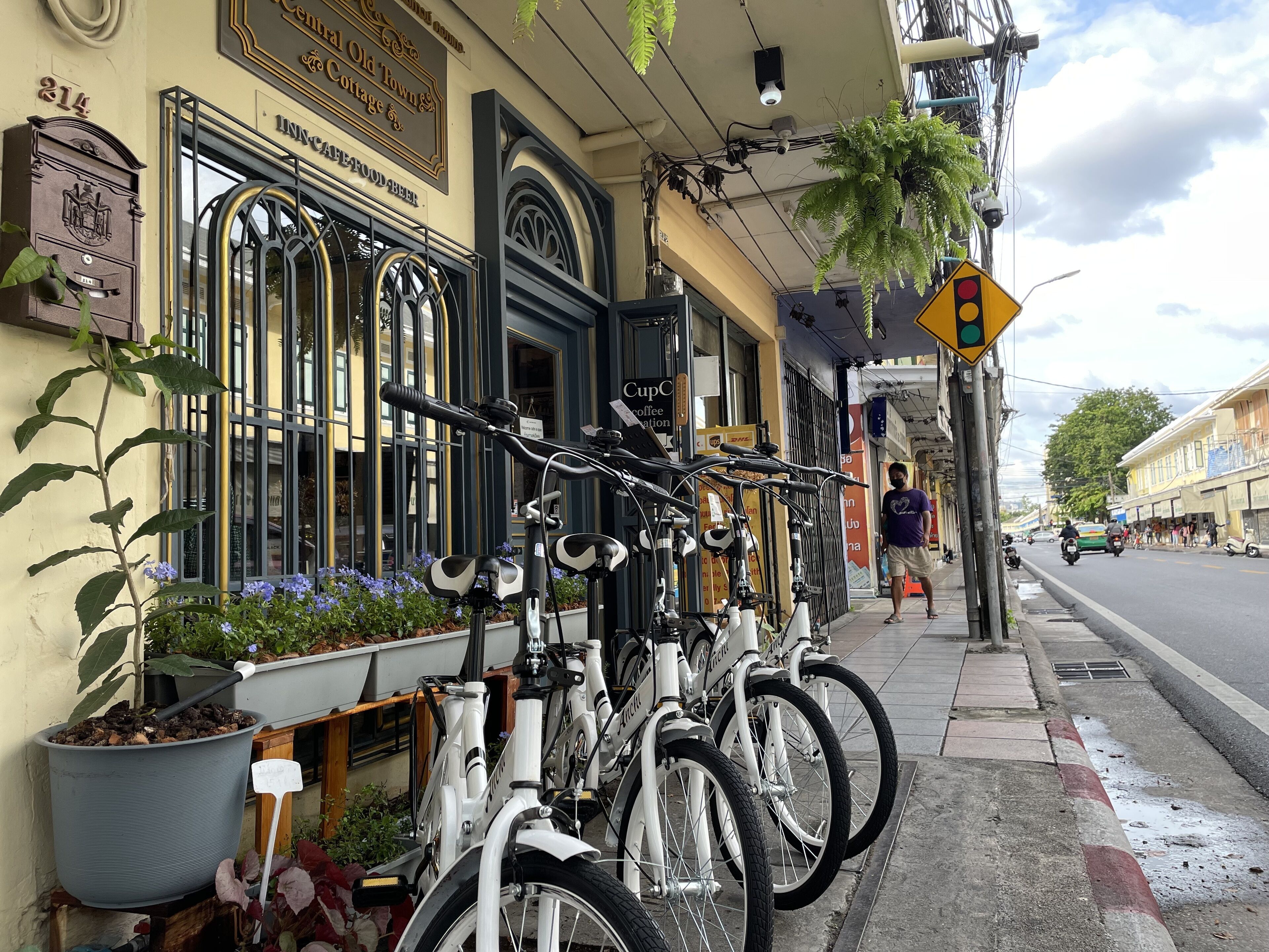 A row of bicycles parked outside a building with a sign that reads "Central Old Town & Cottage."