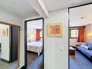 A room with a bed, a sofa, and a painting on the wall. - Ski-in, 2 rooms, 5 guests, Les Menuires (Les Menuires)