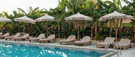 2 outdoor pools, open 7 AM to 7 PM, pool umbrellas, pool loungers