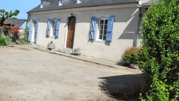 A two-story house with a front door, blue shutters, and a gravel driveway. - Homerez - House in Bernac-Dessus (Bernac-Dessus)
