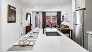 A modern kitchen with a central island, stainless steel appliances, and a view to the outside. - Can't Beat Location! Enjoy the Balcony, Close to Gondola & Town Park (Telluride)