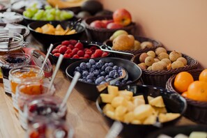 A variety of fruits and jams on a table.