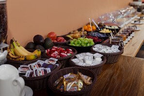 A buffet table with various food items including fruits, nuts, and packaged snacks. - Hotel Castle Rastatt (Rastatt)