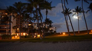 A beachfront hotel with multiple floors, palm trees, and a moon in the sky. - Exceptional 5-stars Beach Villas at Ko Olina - 3 Bedrooms & 3 Full Bathrooms (Ko Olina)