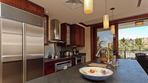 A modern kitchen with stainless steel appliances, wooden cabinets, and a large island with a bowl of fruit. - Exceptional 5-stars Beach Villas at Ko Olina - 3 Bedrooms & 3 Full Bathrooms (Ko Olina)