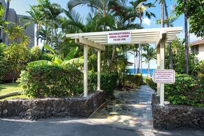 A gated entrance with a sign indicating the recreational area closes at 10:00 PM. - Spacious 2BR/2BA Condo - Ocean View, Above it All, Oceanside Pool and 3 Zone A/C (Kailua-Kona)