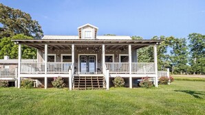 A two-story house with a porch, a front door, and a small balcony.