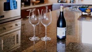 A kitchen with a wine bottle and two glasses on the counter. - Best value !! Luxury Beach Front Condo (Emiliano Zapata)