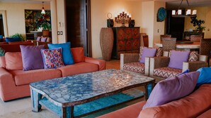 A living room with a sofa set, a coffee table, and a patterned cabinet. - Best value !! Luxury Beach Front Condo (Emiliano Zapata)