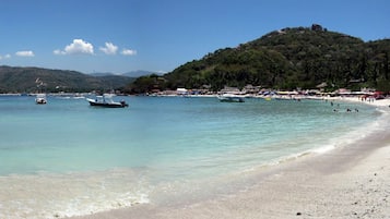 On the beach, sun-loungers, beach towels