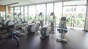 A gym with various exercise machines, large windows, and a clear view of the outside. - Superb Room 500mMRT KLCC Pavillion Bukit Bintang (Kuala Lumpur)