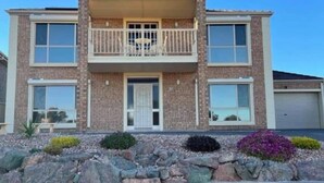 A two-story house with a balcony, a garage, and a landscaped front yard. - 'The Shack' Copper Cove Marina - Only Steps to North Beach (Wallaroo)