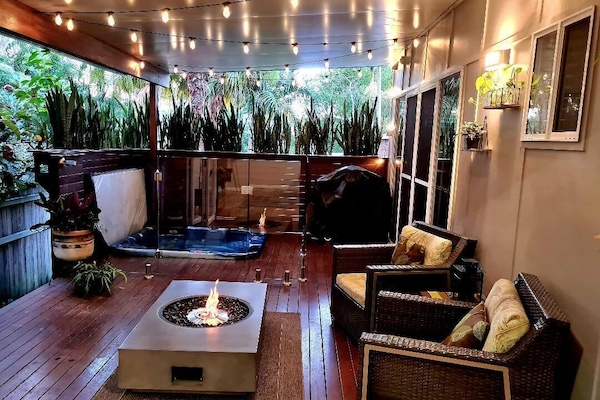Private outdoor area with heated spa and fire table