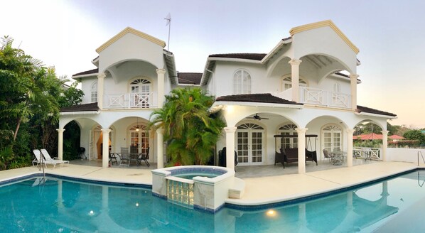 A large house with a swimming pool, multiple balconies, and outdoor seating areas. - Beautiful spacious holiday home private shared pool with neighbour nr Sandy Lane (St James)