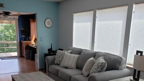 A living room with a grey sofa, a wooden coffee table, and a white side table. - LAKE ACCESS & GREAT VIEWS! MINUTES TO THE WHITE RIVER!! 3 BR/2BA, 1500 sq. ft. (Bull Shoals)