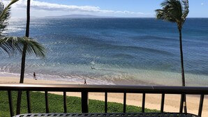 A beach view with palm trees and ocean waves. - Amazing Ocean Front at Sugar Beach Resort #519, High End Remodel, 1Bed/1Bath (Kihei)