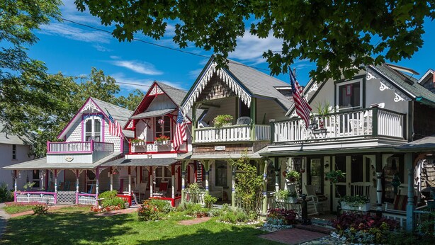 A traditional two-story house with a porch, multiple windows, and a well-maintained garden. - Magical House in the Trees with Water View - Secluded Area (Aquinnah)