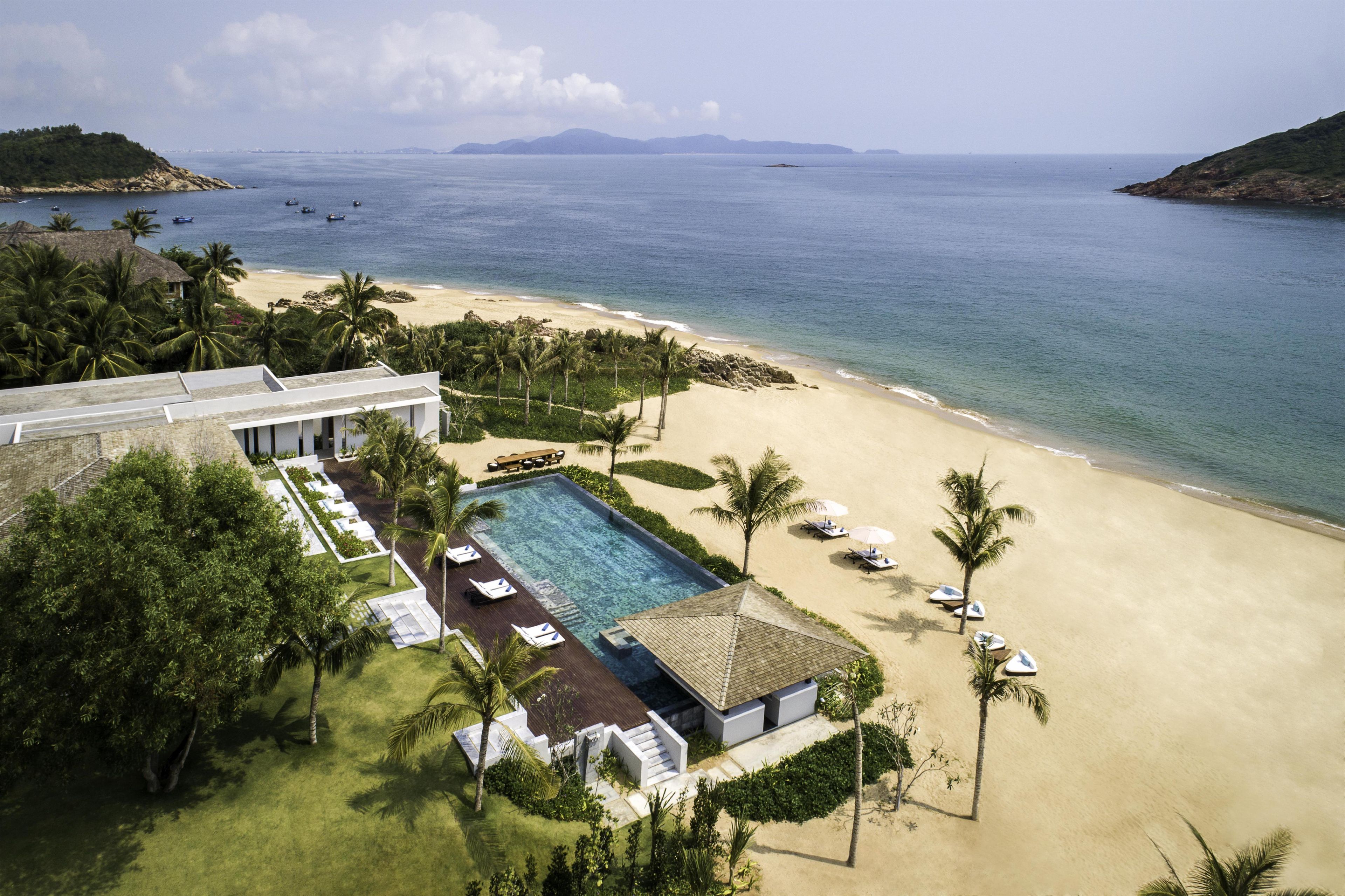 A resort with a swimming pool, beach, and ocean views.