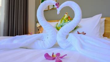 A cozy retreat awaits, complete with a plush bed and a delicate orchid.