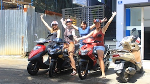 A group of people on scooters parked on a street. - Dalat Sky Hostel (Xuan Huong - Da Lat)