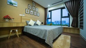 A modern bedroom with a large bed, a desk, and a view of the city through a large window. - Vistay (Hanoi)