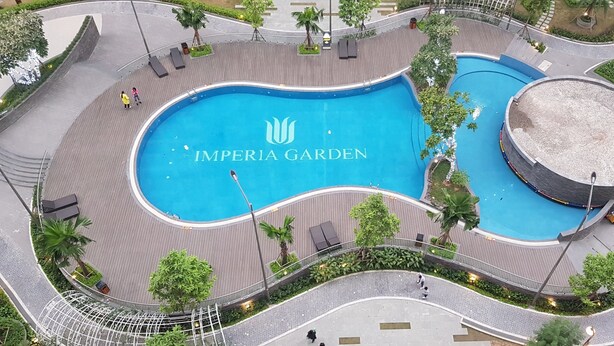 An aerial view of the Imperial Garden with a central pool, surrounding walkways, and palm trees. - Vistay (Hanoi)