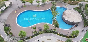 An aerial view of the Imperial Garden with a central pool, surrounding walkways, and palm trees. - Vistay (Hanoi)