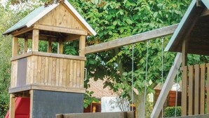 A wooden play structure with a red slide and a lookout tower. - 1 bedroom gorgeous home in Schlitz-Rimbach (Schlitz-Rimbach)