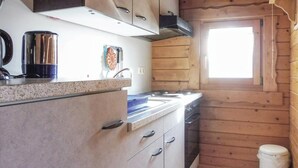 A kitchen with a stove, sink, and cabinets. There is a window with natural light and a trash can. - 1 bedroom gorgeous home in Schlitz-Rimbach (Schlitz-Rimbach)
