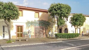 A street with buildings, trees, and a paved road. - Beach front apartment in Porto Alabe (Porto Alabe)