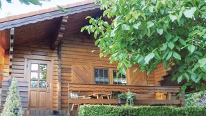 A rustic wooden cabin with a porch, a door, and windows. - 2 bedroom nice home in Schlitz-Rimbach (Schlitz-Rimbach)
