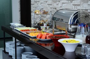 A buffet with various food items and a coffee machine. - Dream Tower (Batumi)