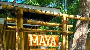 A bamboo structure with signs advertising 'Maya Playa Resort', 'Italian Cuisine Coffee Shop', and 'Tours Diving'. - Maya Playa (Panglao)