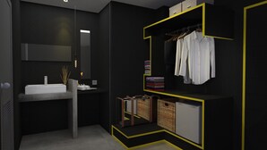 A modern bathroom with a large mirror, a sink, and a built-in wardrobe with hanging clothes.