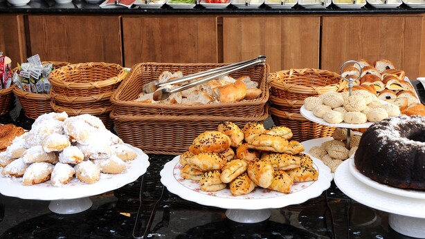 A buffet with various food items and baskets of bread. - Biga Casa Grande Otel (Biga)