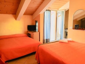 Triple Room, Balcony | In-room safe, individually decorated, individually furnished, desk