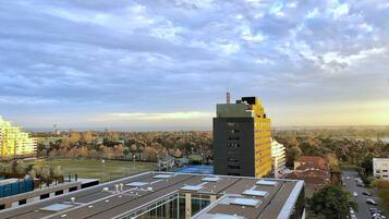 A modern building with a flat roof, large windows, and a prominent antenna.