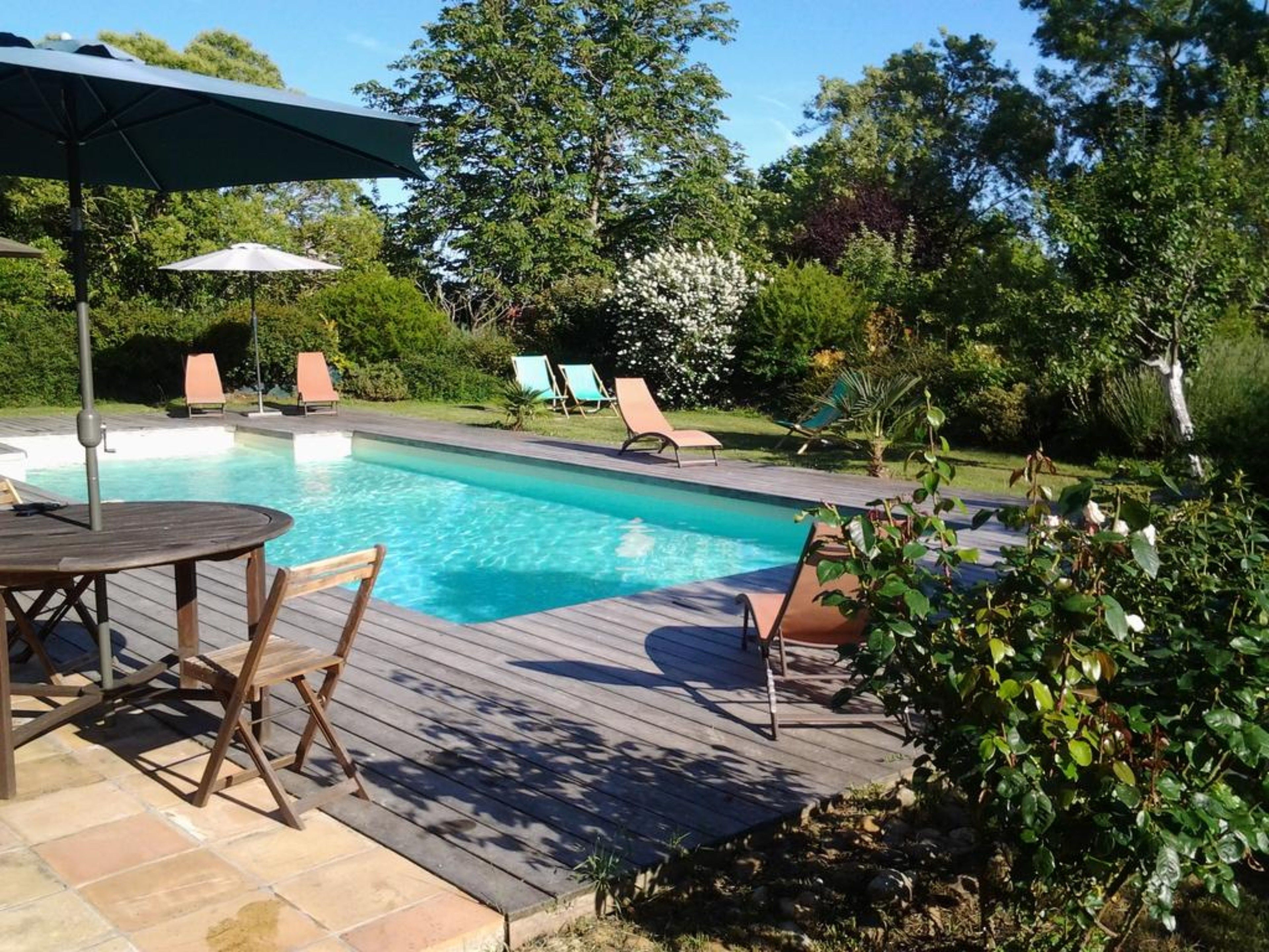 Una piscina al aire libre, tumbonas