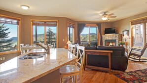 A spacious living area with a kitchen, dining table, and seating.