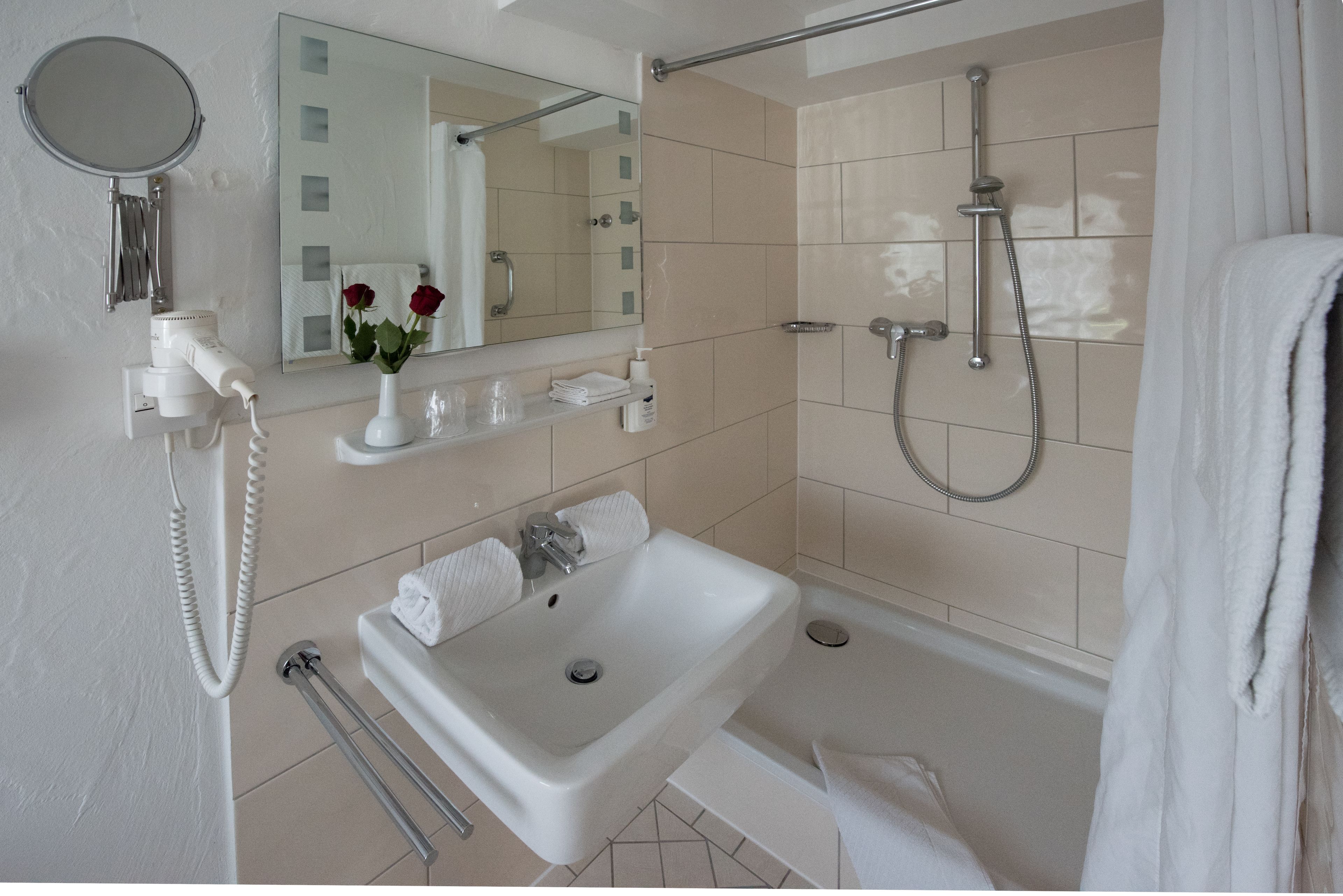 deep-soaking bathtub, rainfall showerhead, hair dryer, bathrobes