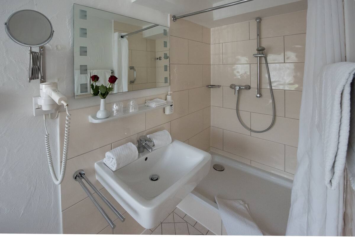 deep-soaking bathtub, rainfall showerhead, hair dryer, bathrobes