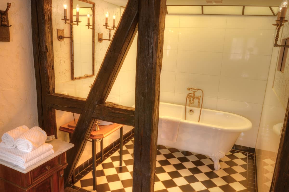 suite (habsberg) | bathroom | deep-soaking bathtub, rainfall showerhead, hair dryer, bathrobes