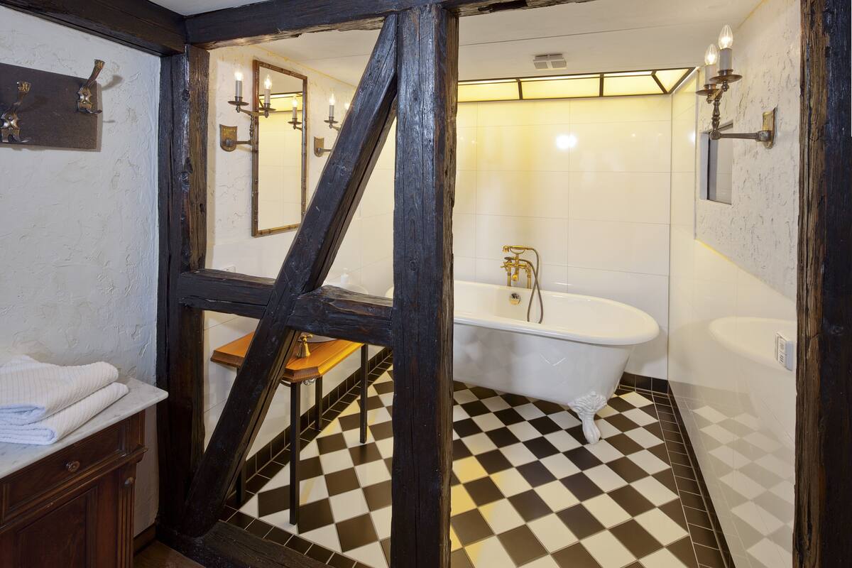 suite (habsberg) | bathroom | deep-soaking bathtub, rainfall showerhead, hair dryer, bathrobes