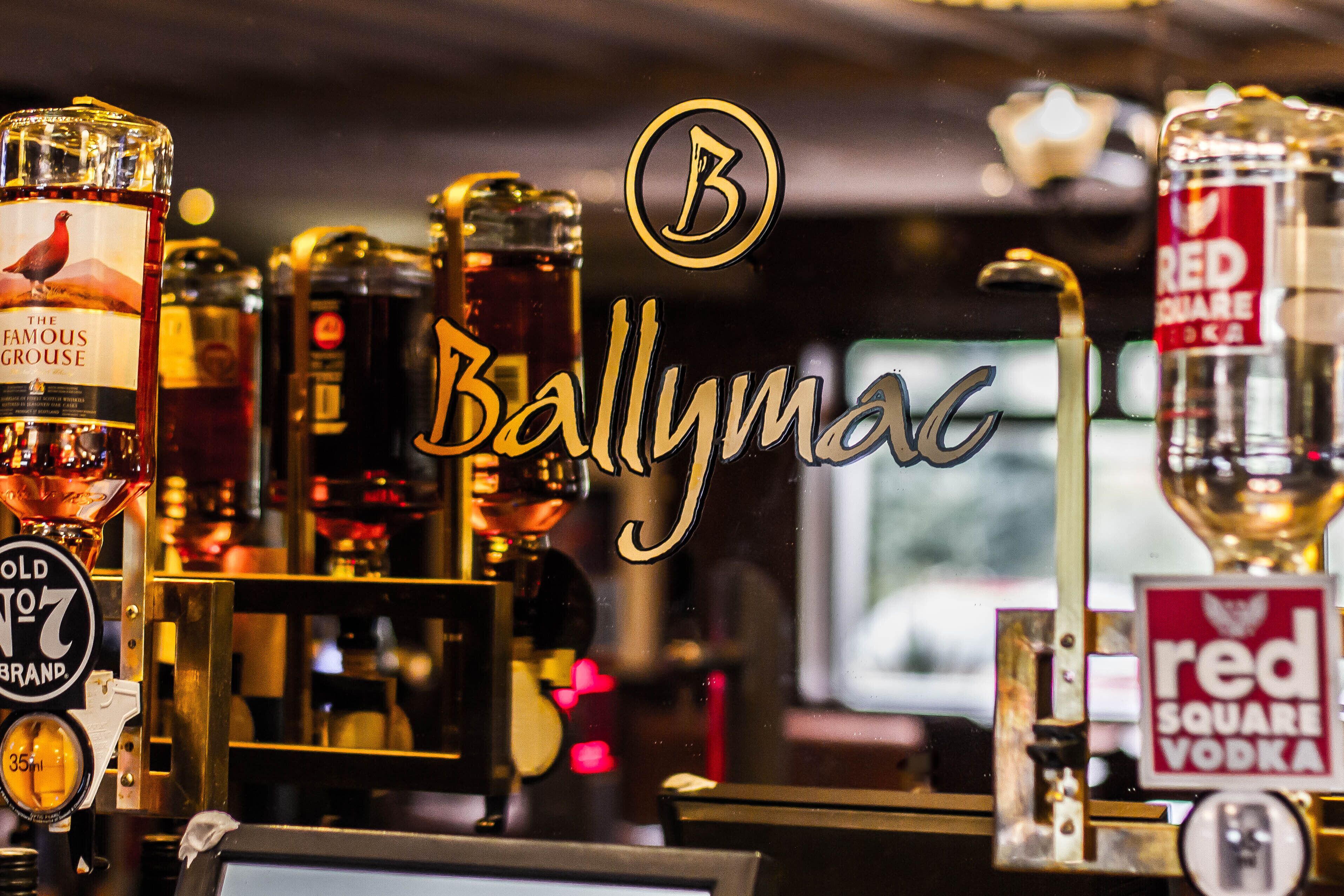 A bar with various bottles of alcohol, including 'The Famous Grouse' and 'Red Square Vodka'.