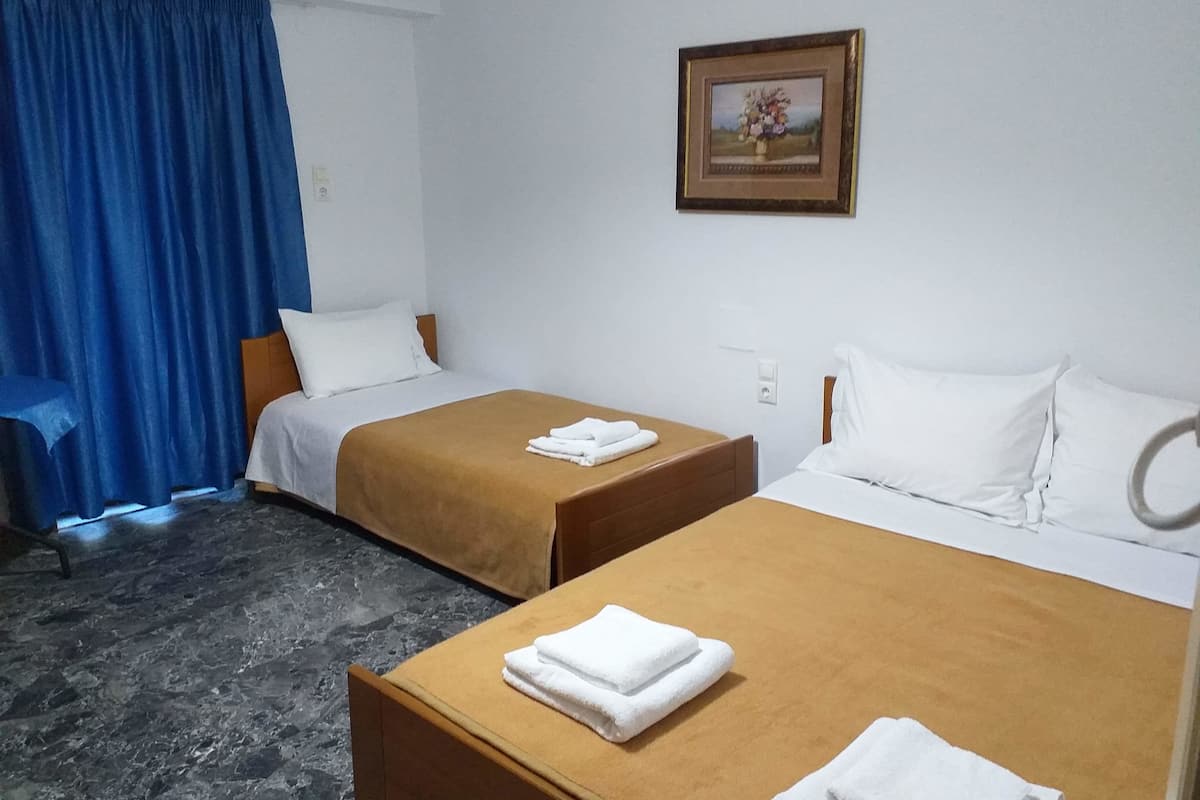 Family Triple Room, 1 Bedroom, Balcony, Partial Sea View | 1 bedroom, in-room safe, soundproofing, iron/ironing board