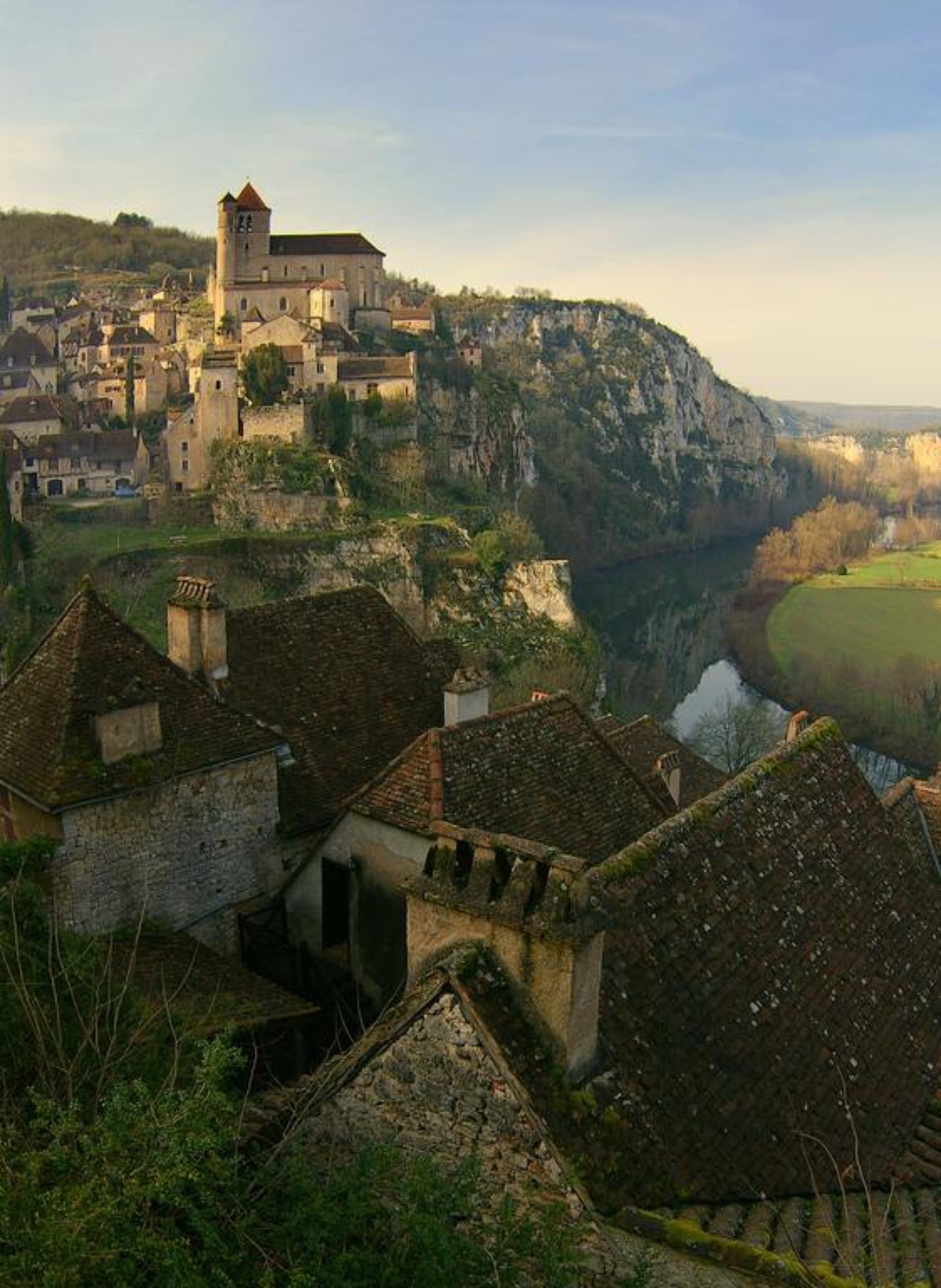 Un pueblo histórico con arquitectura medieval, que incluye una torre destacada y murallas fortificadas.