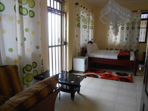 Luxury Room | Living area | 24-inch flat-screen TV with satellite channels, TV