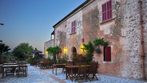 A rustic building with stone walls and wooden furniture. - Finca Ses Cases Noves (Sant Llorenc des Cardassar)