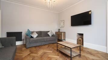 Deluxe Apartment, Multiple Beds | Living room | 49-inch LCD TV with premium TV channels, TV, Netflix
