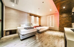 A modern bedroom with two beds, a desk, and a built-in wardrobe. - Madoka (Gyeongju)